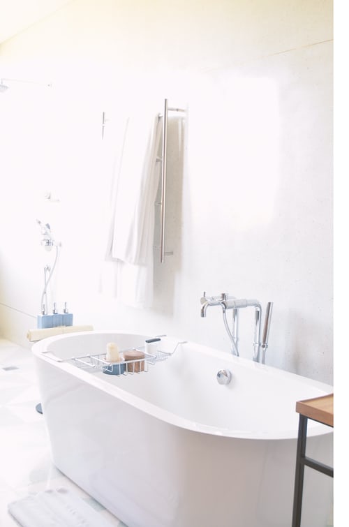 A beautifully reglazed bathtub with silver tap and caddy