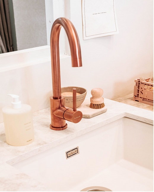 Luxurious looking rose gold faucet and shallow sink