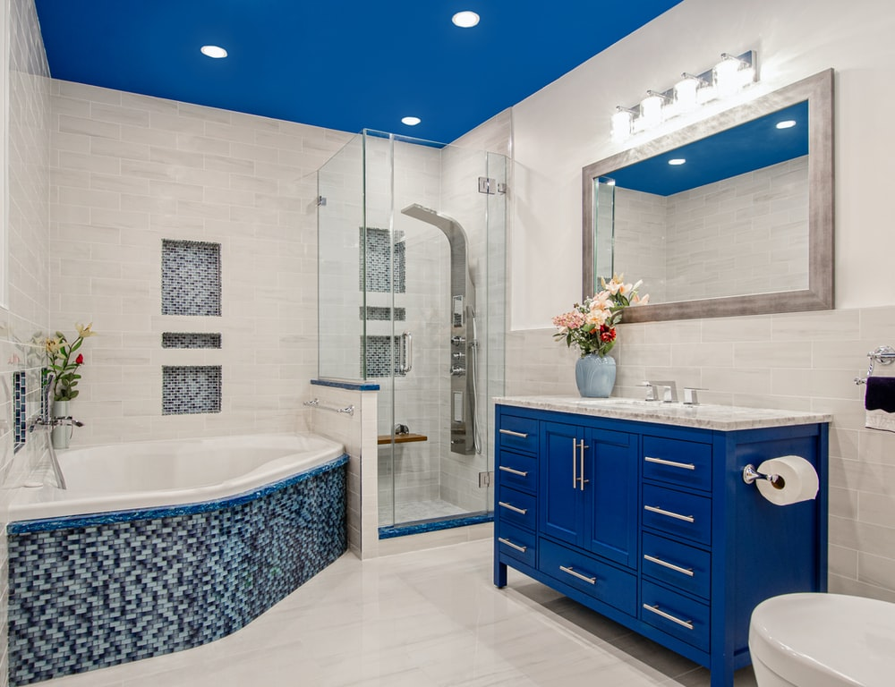 A blue-themed bathroom with shiny tiles