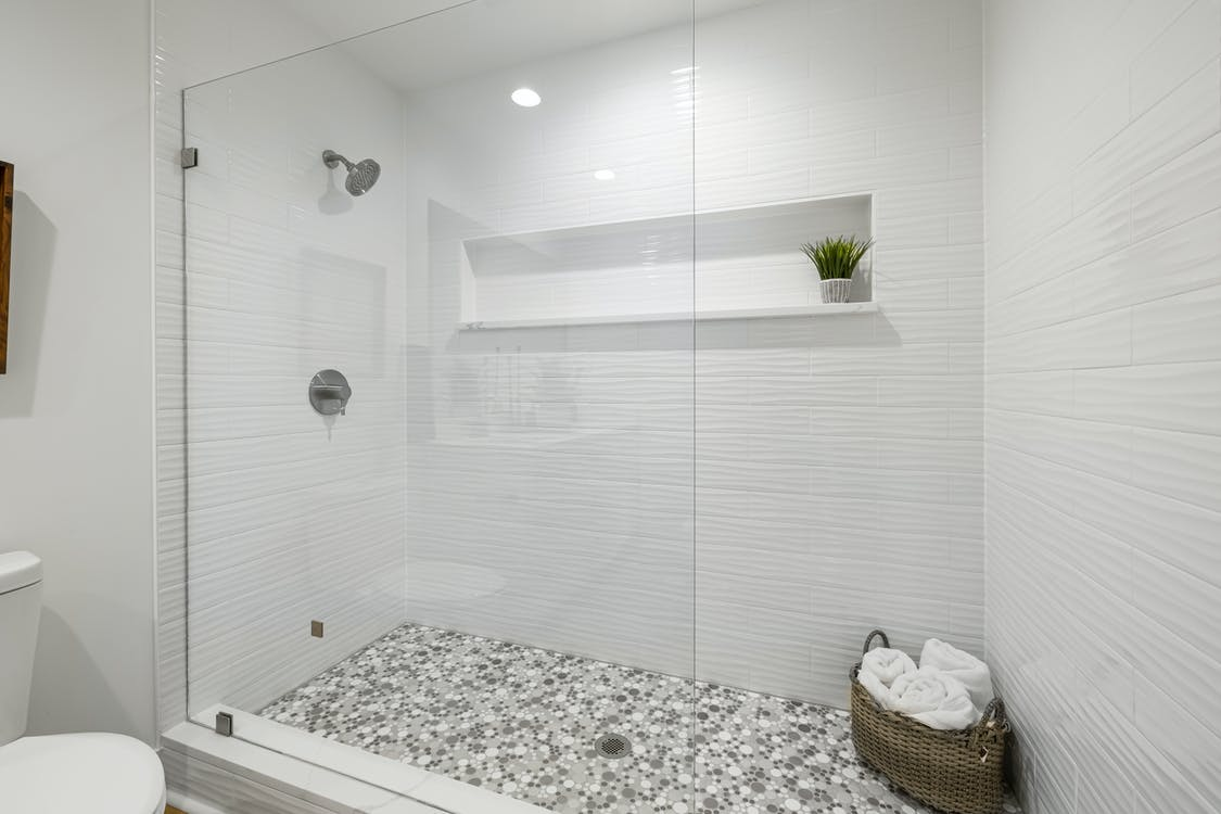 A bathroom with a modern-style shower
